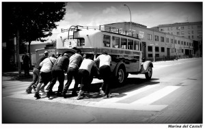 Pushing a car.